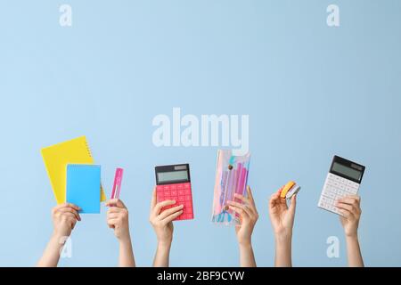 Many hands with school supplies on white background Stock Photo - Alamy