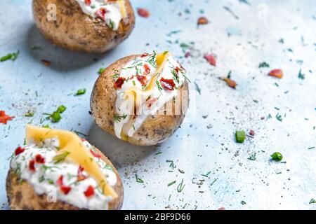 Tasty baked potato with sour cream on color background Stock Photo