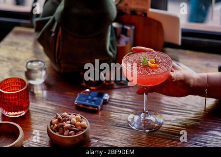 Transparent glass Grapefruit and mint leaf piece of mineral water in the hands of women Stock Photo