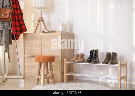 Stylish interior of modern hall with winter clothes Stock Photo