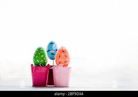 Three of Easter eggs painted decoration with colourful on pot Stock Photo