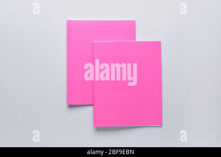 Two notebooks on grey background Stock Photo