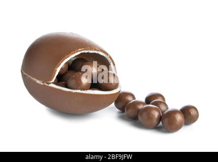 Sweet chocolate egg and candies on white background Stock Photo