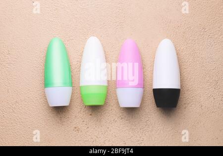 Different deodorants on color background Stock Photo