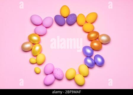 Frame made of beautiful Easter eggs on color background Stock Photo