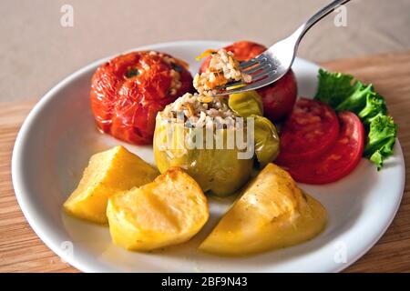 'Gemista' (or 'Yemista'), a traditional Greek food. Vegetables (tomatoes, ball peppers, potatoes etc.) filled with rice (sometimes also ground meat). Stock Photo