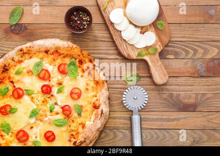 Composition with delicious pizza Margherita on wooden background Stock Photo