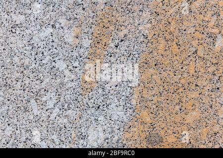 Texture gray granite. Smooth light stone texture. Uniform surface with stone grinding. Gray stone with dark inclusions. Material for decoration, backg Stock Photo