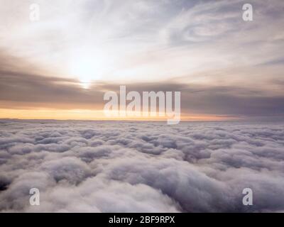 Evening sun over England with the aircraft just above the clouds Stock Photo