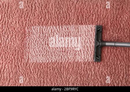 Hoovering of carpet with vacuum cleaner, top view Stock Photo