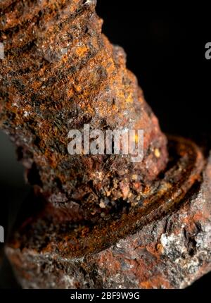 Rusted screw closeup view on black background Stock Photo