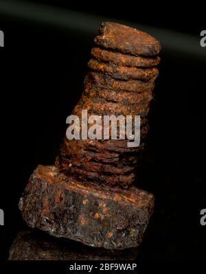 Rusted screw closeup view on black background Stock Photo