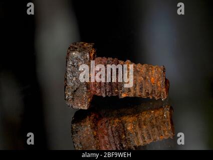 Rusted screw closeup view on black background Stock Photo