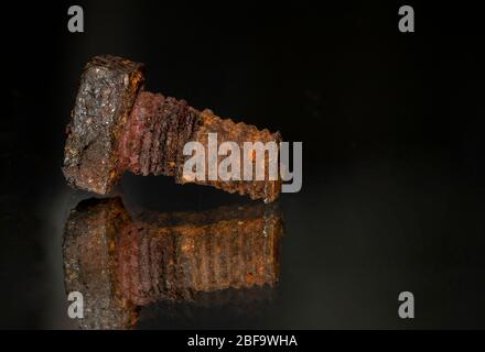 Rusted screw closeup view on black background Stock Photo