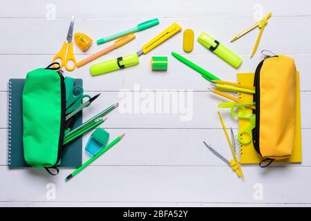 Pencil case and school stationery on wooden background Stock Photo