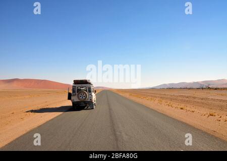 Roadtrip through the Namibian desert in a 4WD with roof top tent. Adventure holiday. Stock Photo