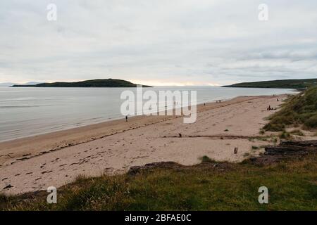 View along Big Sand beach with Long Island in the distance and the Outer Hebrides on the horizon at dusk, Gairloch, Scotland, UK. Stock Photo