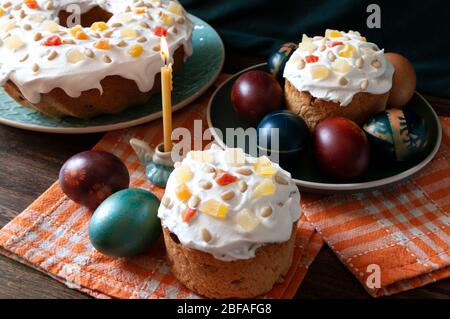 Traditional Orthodox Easter bread the kulich, russian food, religion, painted eggs, candle, home made. Stock Photo