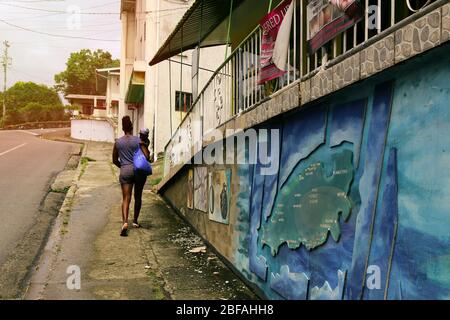 Caribbean, Trinidad and Tobago - February 05, 2018. Afro-american mother with cute little daugher walking on the street.