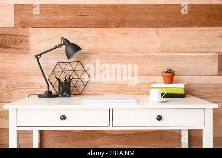 Modern stylish workplace near wooden wall Stock Photo