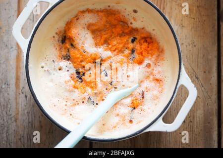 Carrot cake batter with beaten eggs, grated carrots & raisins Stock Photo