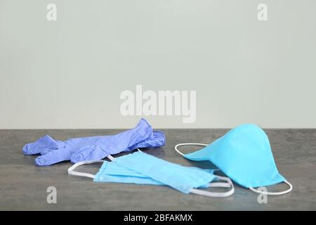 Different medical masks with gloves on table Stock Photo