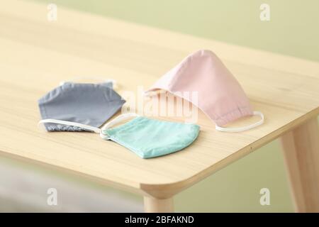 Different medical masks on table Stock Photo
