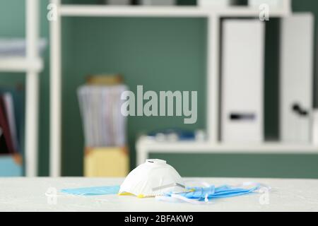 Medical masks on table in clinic Stock Photo