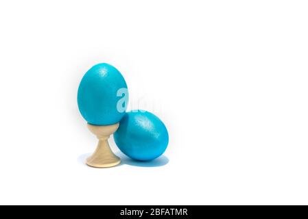 Two colored easter chicken eggs isolated on the white background. One is in holder. Stock Photo