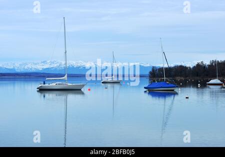 Ammersee Lake, Germany with sailingboats and scenic view on the snow covered alp mountains Stock Photo