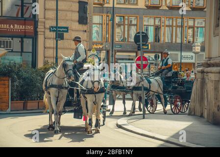 Vienna, Austria - July 27, 2015: Horse-drawn carriages at modern streets of Vienna Stock Photo