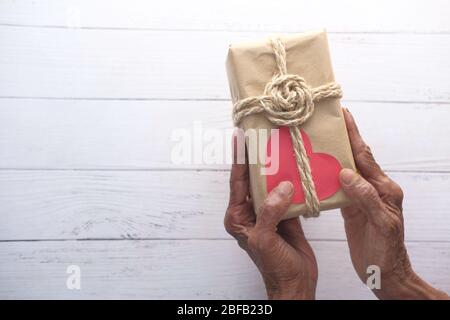 senior women hand holding gift box, top view Stock Photo