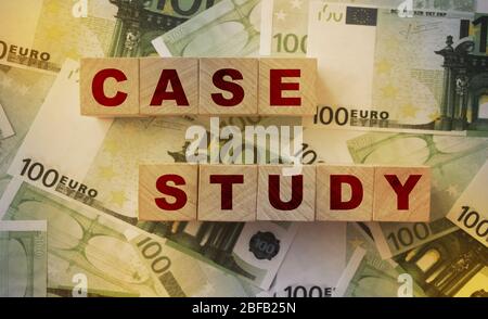Case Study written on a wooden cubes on 100 Euro banknotes. Business startup and development concept Stock Photo