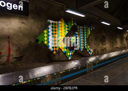 Sweden, Stockholm, May 30, 2018: underground metro tunnelbana station Vastra Skogen (blue line, central station) colorful patterned caves walls and ce Stock Photo