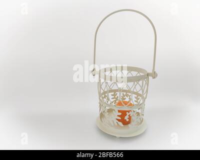 Vintage lantern with an orange candle on the white backdrop. Concept - Ramadan kareem holiday celebration. Royalty Free Stock photo Stock Photo