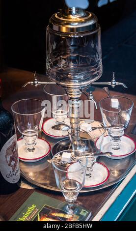 Paris, France - December 2014: Glasses and water dispenser for making the drink Absinthe Stock Photo