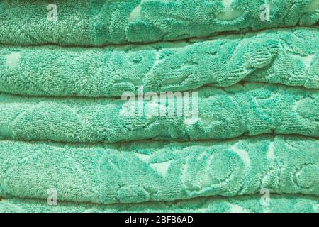 Score. Shelves with towels. Bath accessories. Terry towels are beautiful neat stacks. Colour. Life style. Texture. Organization of space. Flying lady. Stock Photo