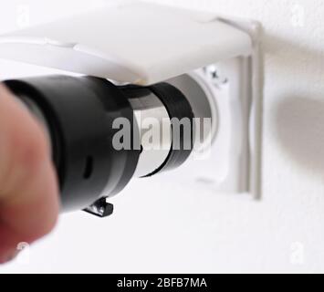 Central vacuum cleaner hose laid on the floor in the living room. Cleaning room conceptual shot. Stock Photo