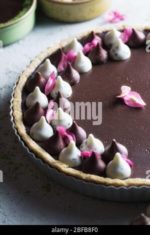 Homemade dark chocolate tart close up with copy space. Stock Photo