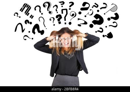 Stressed business woman question marks above head. Pulling hair. A young businesswoman is completely stressed because full of questions and doubts. Stock Photo
