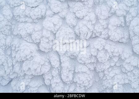 Icy texture of snow after a blizzard on a windy morning. Stock Photo