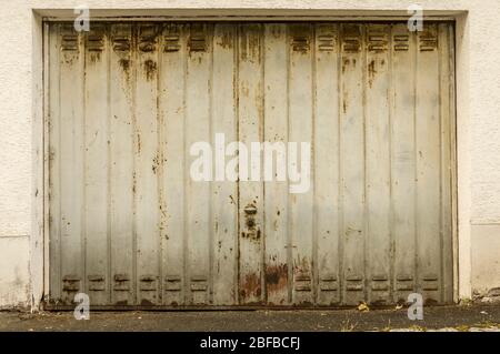 old, light gray and rusty garage door in vintage look Stock Photo