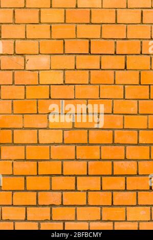 Wall of bright, red brick in closeup Stock Photo