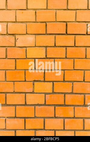 Wall of bright, red brick in closeup Stock Photo