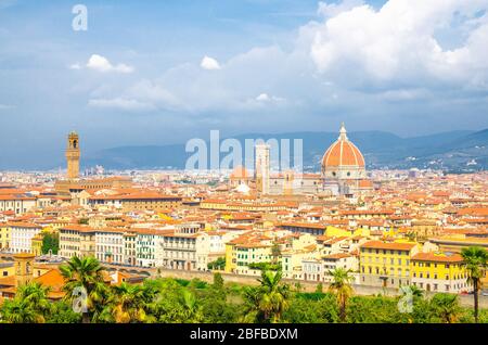 Top aerial panoramic view of Florence city with Duomo Cattedrale di Santa Maria del Fiore cathedral, buildings houses with orange red tiled roofs and Stock Photo