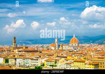 Top aerial panoramic view of Florence city with Duomo Cattedrale di Santa Maria del Fiore cathedral, buildings houses with orange red tiled roofs and Stock Photo