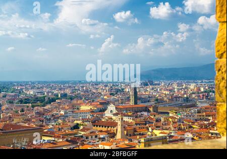 Top aerial panoramic view of Florence city historical centre, Basilica di Santa Maria Novella, buildings houses with orange red tiled roofs, blue sky Stock Photo