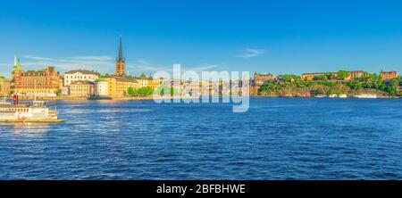 Panoramic view of Riddarholmen island district with Riddarholm Church spires, typical sweden colorful gothic buildings, Lake Malaren, Sodermalm island Stock Photo