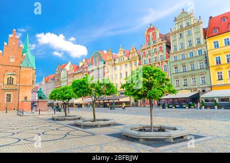 Row of colorful buildings with multicolored facade and Old Town Hall building on cobblestone Rynek Market Square in old town historical city centre of Stock Photo