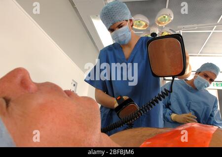 Doctors using a defibrillator to resuscitate a male heart attack victim Stock Photo